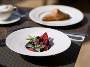 A plate of fresh fruit on a table.