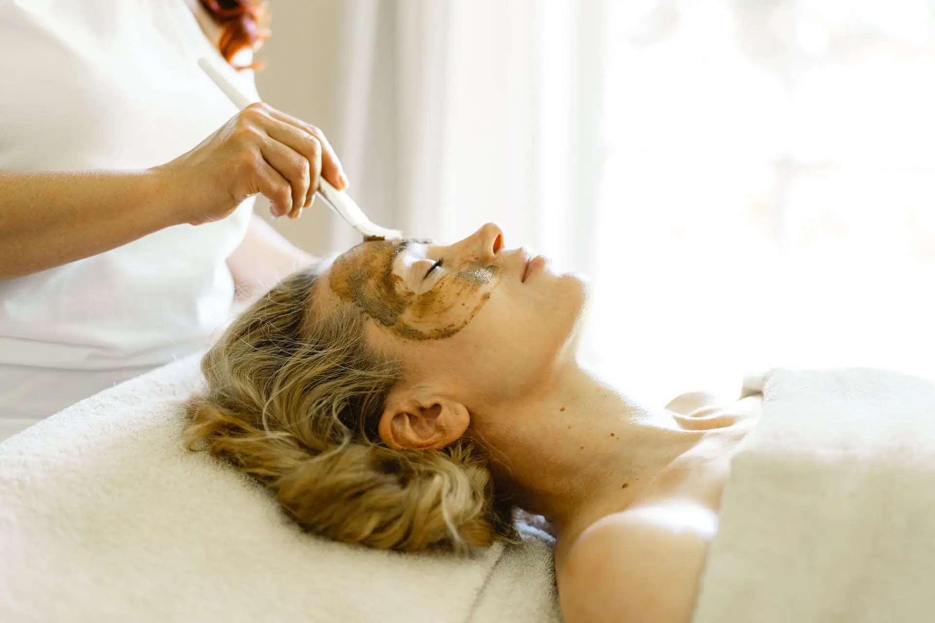 SPA-Anwendung Eine Frau erhält eine Gesichtsmaske.