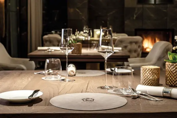 Elegant table decoration with wine glasses and plates on a laid table.