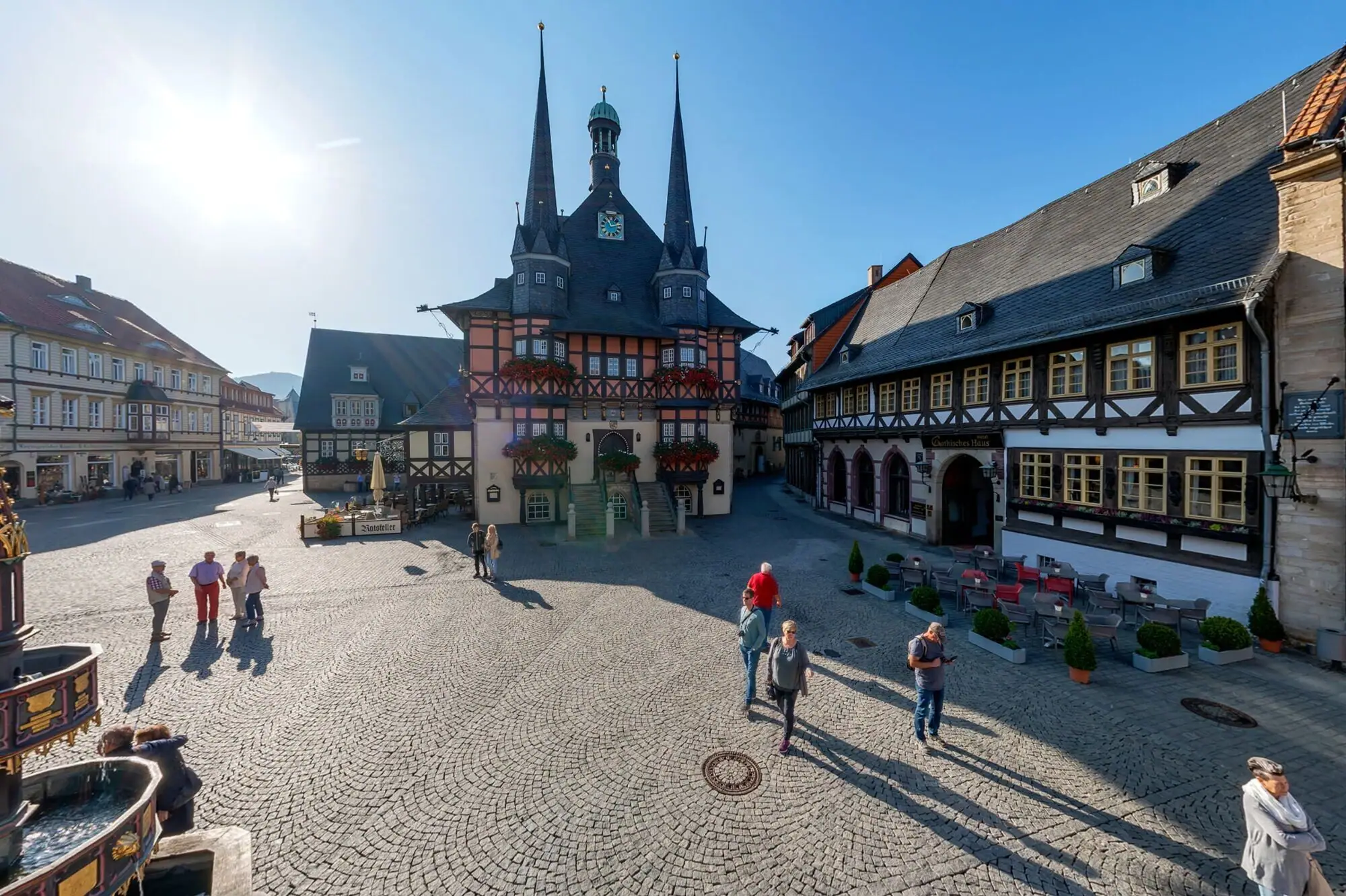 Marktplatz Wernigerode Eine Gruppe von Menschen, die über einen Marktplatz spazieren geht.