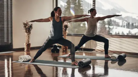 A group of women practicing yoga indoors.