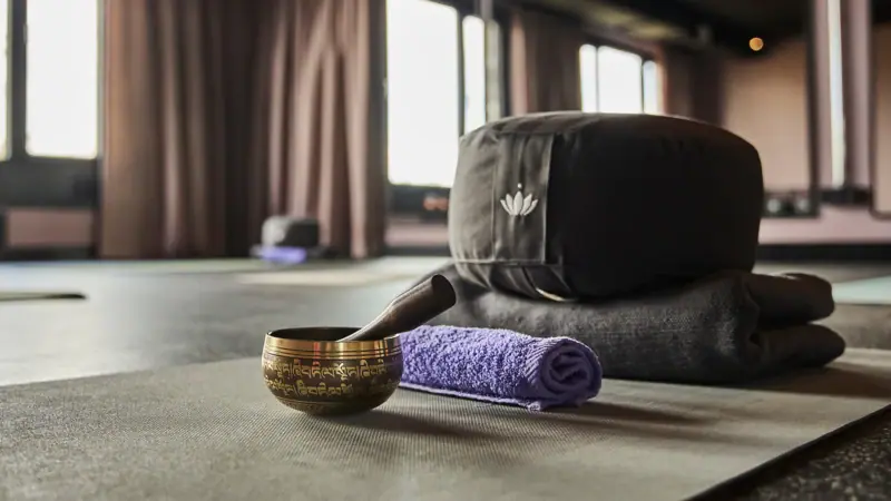 Yogamatte mit einer Schüssel und einem Handtuch darauf