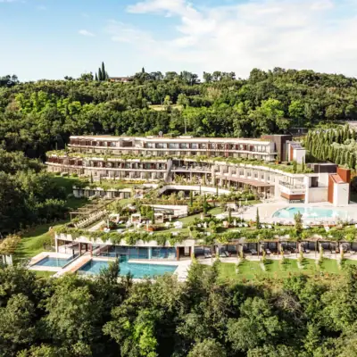 Ein Gebäude mit einem Pool, umgeben von Bäumen.