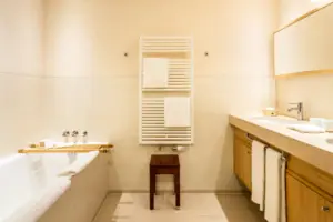Badezimmer mit Badewanne und Waschbecken, ausgestattet mit Armaturen und Badezimmerzubehör.