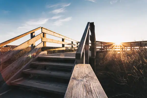 Holztreppe, die zu einem Feld führt