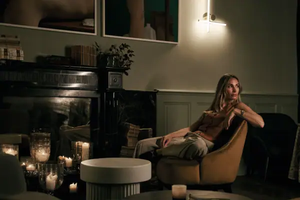 Eine Frau sitzt auf einem Stuhl in einem Innenraum.