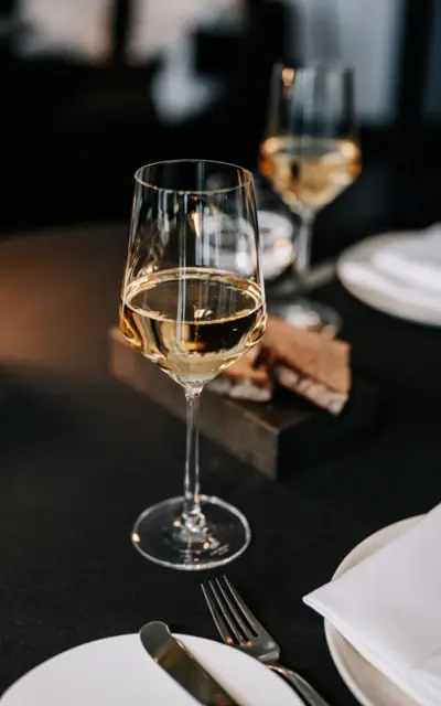 A glass of wine on a table.