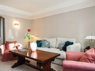 Living room featuring a couch with pillows and a coffee table.