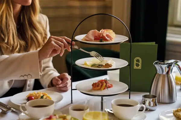Eine Frau hält eine Gabel über Tellern mit Essen.