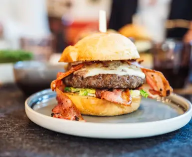 Burger mit Speck auf einem Teller