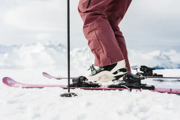 A person skiing on a snowy slope, equipped with skis and poles.