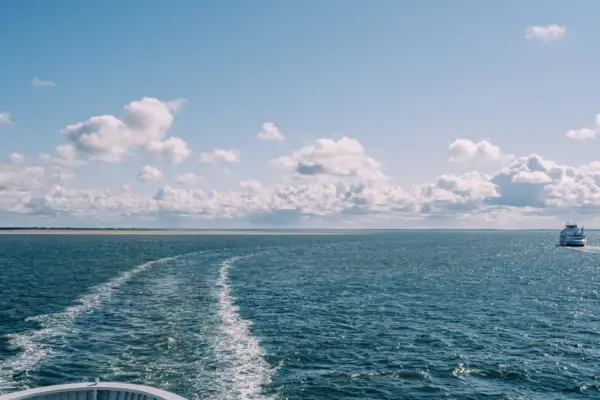 Ein Boot auf dem Wasser unter einem bewölkten Himmel.