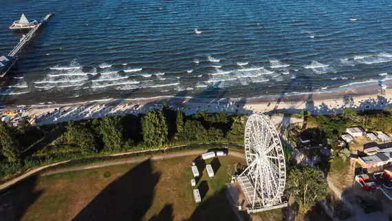 Ferris wheel next to a beach.