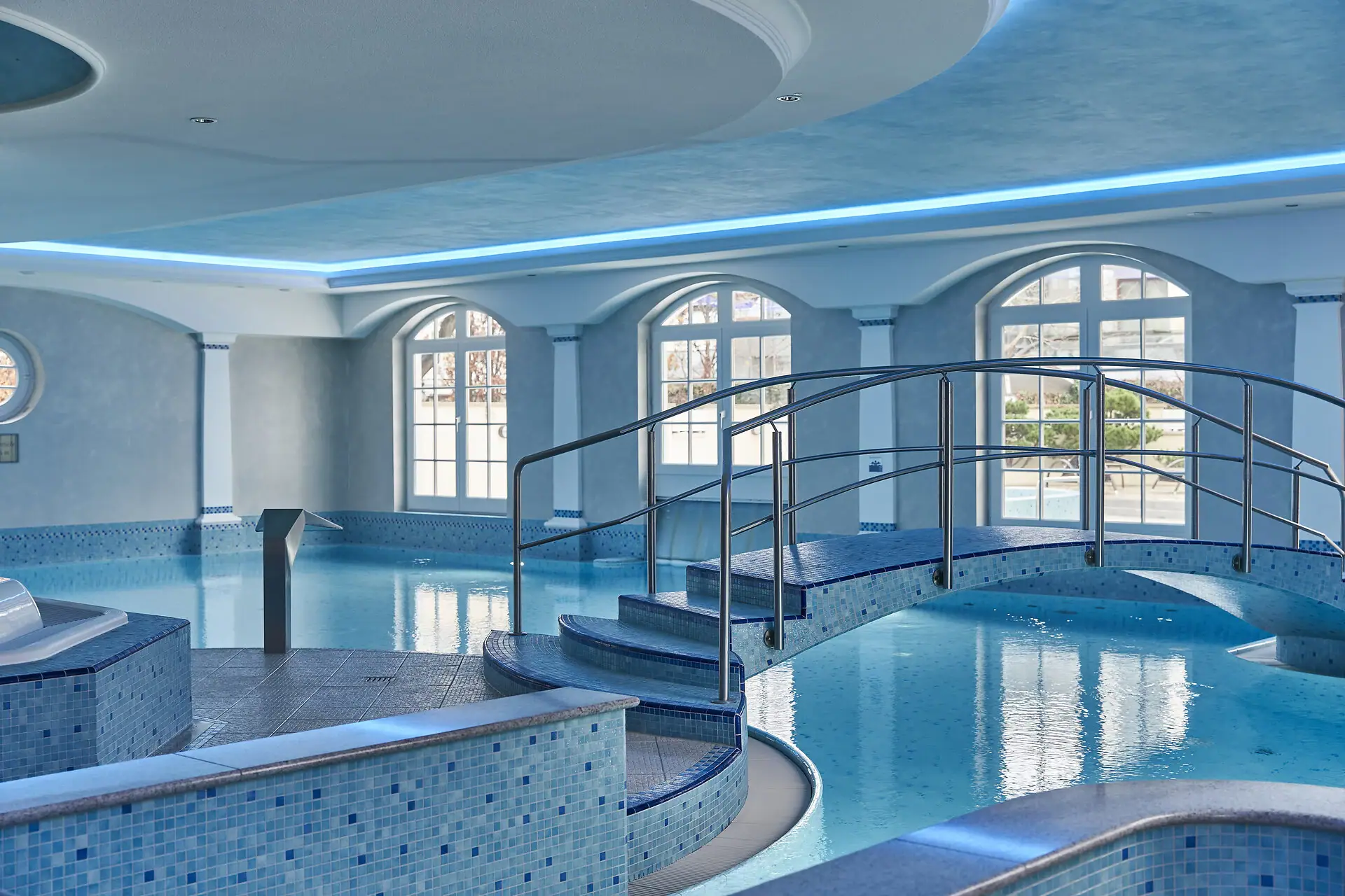 Bcklick in einen blau gefliesten Poolbereich, Brücke über die Wasseroberfläche