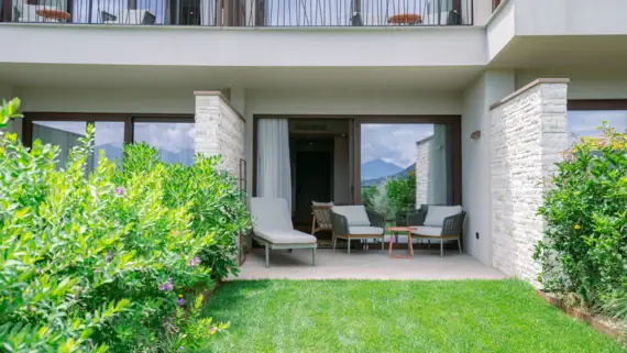 Patio area with chairs overlooking a well-manicured lawn.