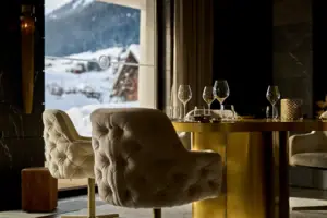 Ein Tisch mit Weingläsern und Blick auf einen verschneiten Berg.