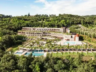 Building with several pools surrounded by trees.