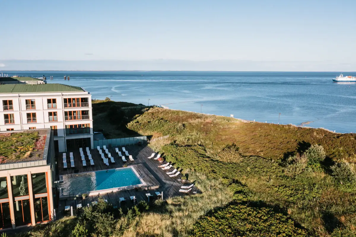 Ein Pool und ein Gebäude mit Wasser im Hintergrund.