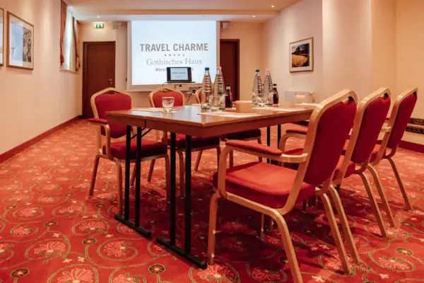 Ein Zimmer mit einem Tisch und Stühlen.