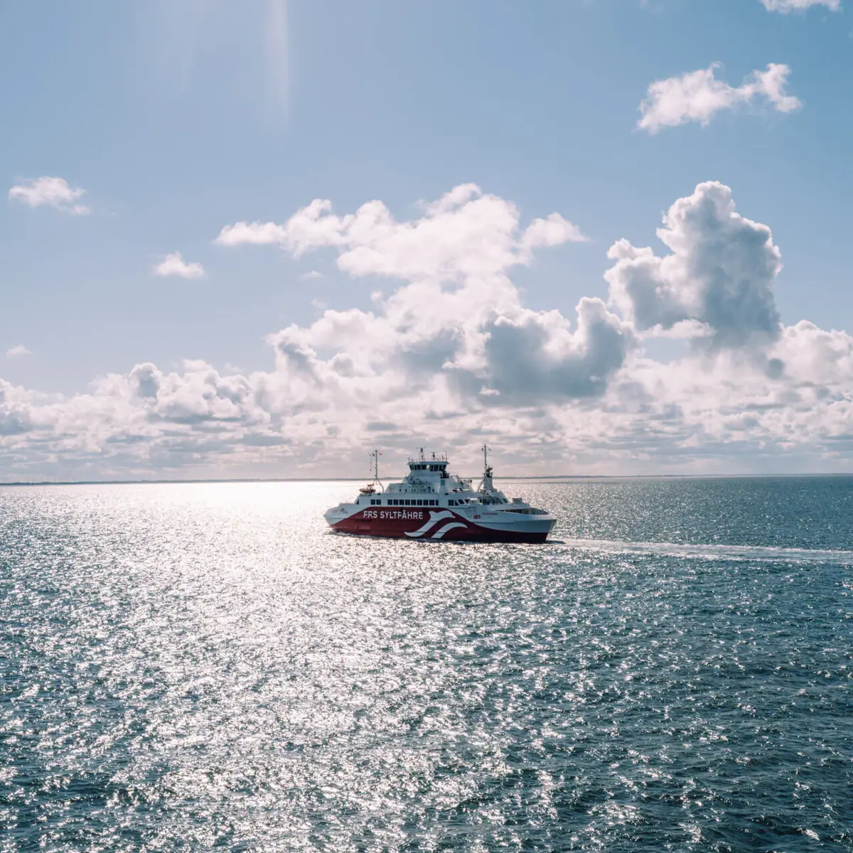 Ein Boot auf dem Wasser unter einem bewölkten Himmel.