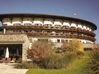 Building with a round roof under a blue sky.