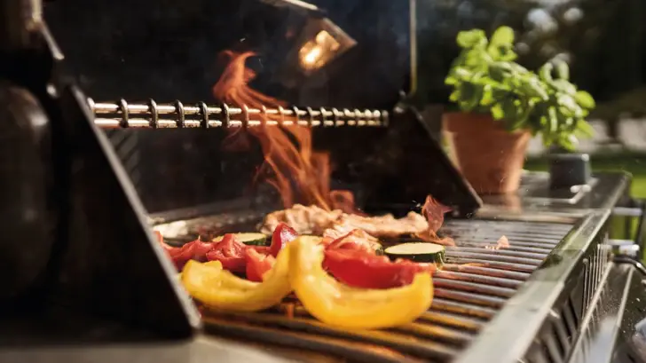 Essen auf einem Grill mit Flammen.
